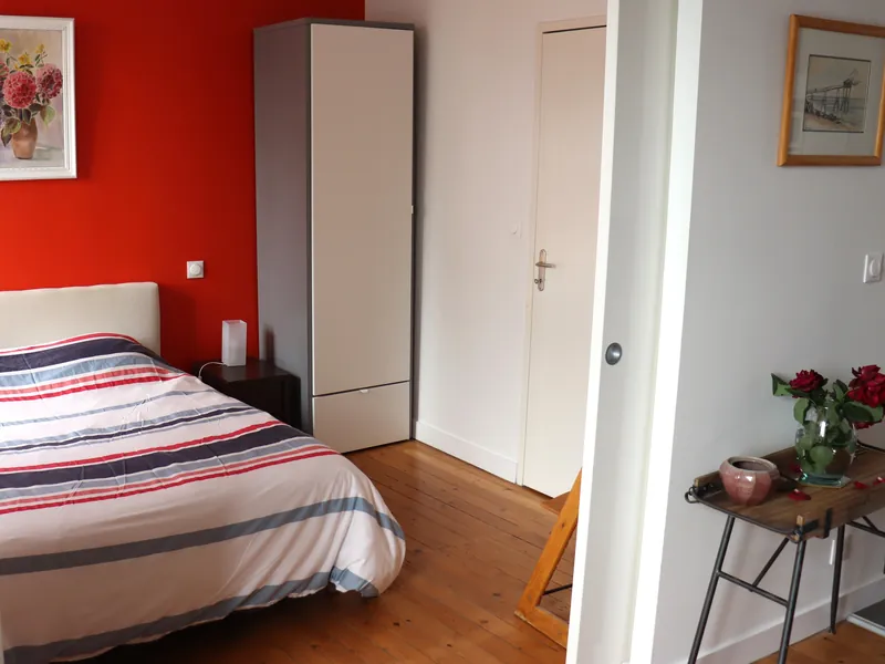 Bedroom of Le Carrousel, looking towards the door and the bedside table